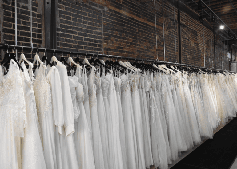 line of dresses on a rack inside the store