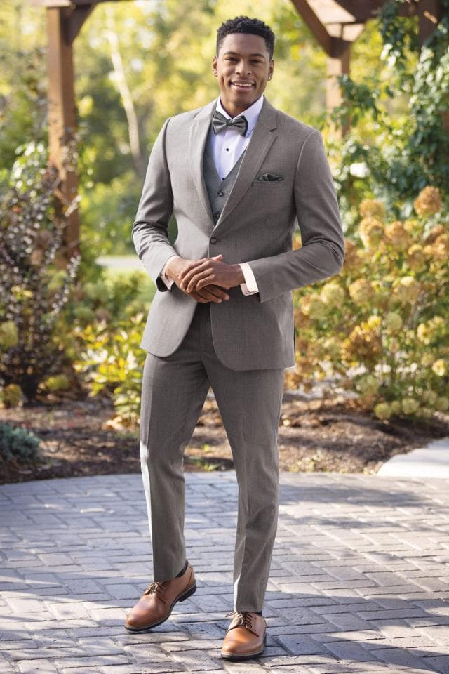 Picture of man in grey tux in front of trees