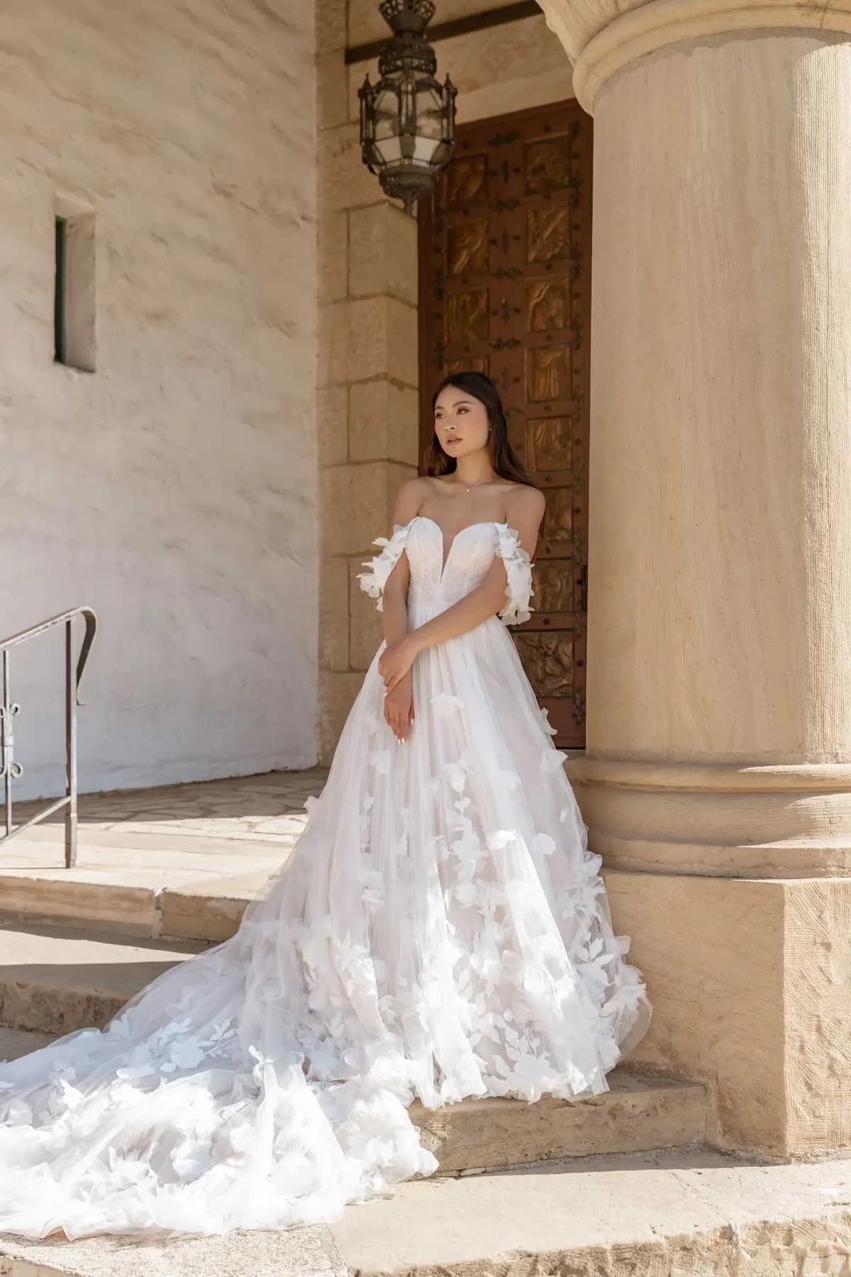 Picture of Essense dress on bride outside on stone steps